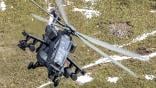 AW249 flying over forested area